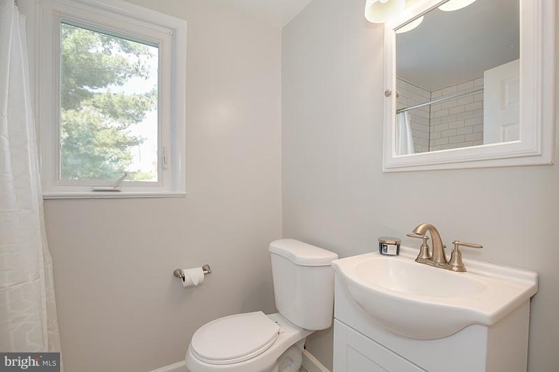 3807 Jeffry Street Silver Spring, MD 20906 - Photo 19 of 26 a white toilet sitting next to a bathroom sink