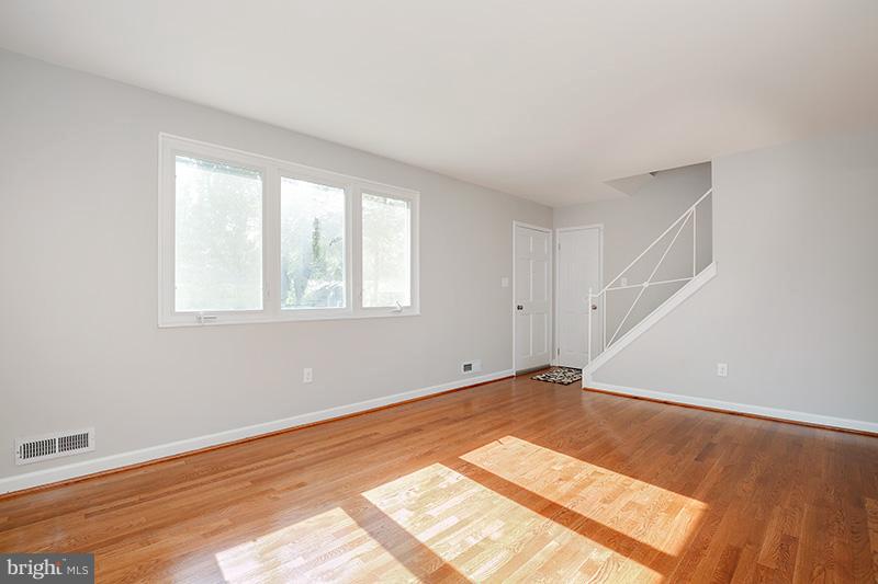 3807 Jeffry Street Silver Spring, MD 20906 - Photo 5 of 26 a view of an empty room with wooden floor and a window