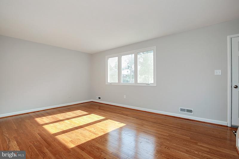 3807 Jeffry Street Silver Spring, MD 20906 - Photo 6 of 26 an empty room with wooden floor and windows