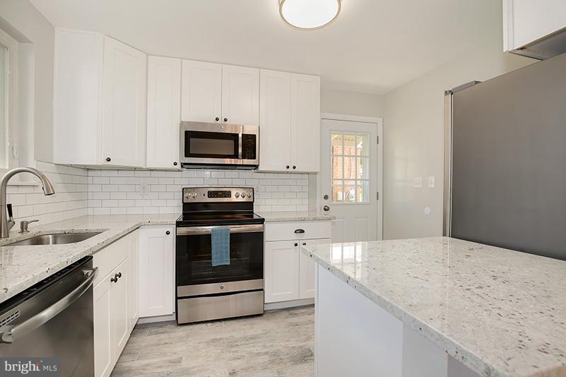 3807 Jeffry Street Silver Spring, MD 20906 - Photo 9 of 26 a kitchen with granite countertop a stove sink and microwave