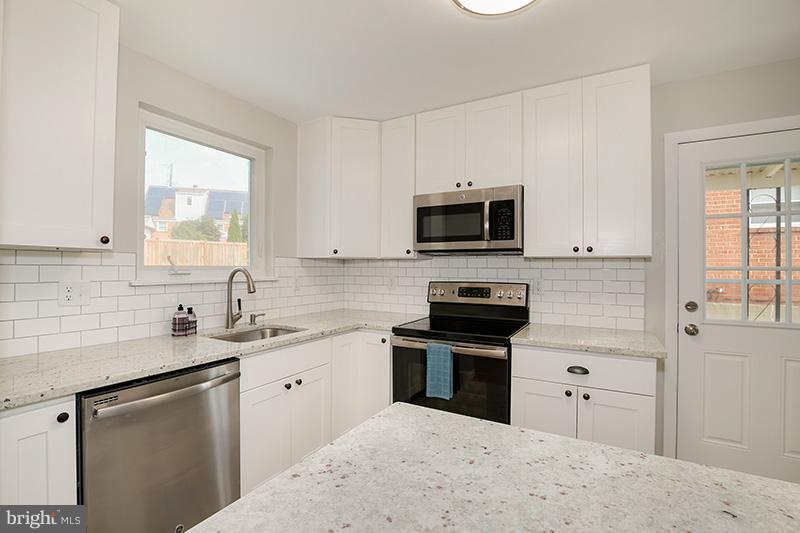 3807 Jeffry Street Silver Spring, MD 20906 - Photo 10 of 26 a kitchen with a sink stove and microwave