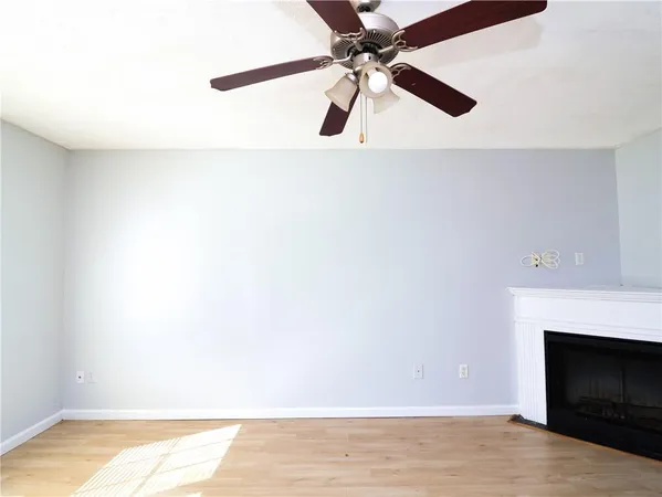 a view of a livingroom with a fireplace and wooden floor