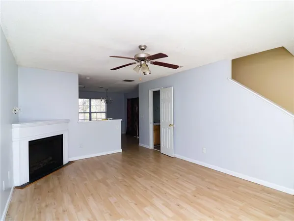 a view of an empty room with a fireplace and a window