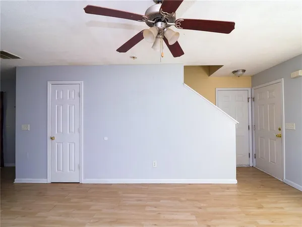 a view of room with a ceiling fan