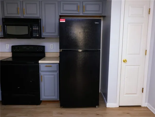 a kitchen with a refrigerator and a microwave