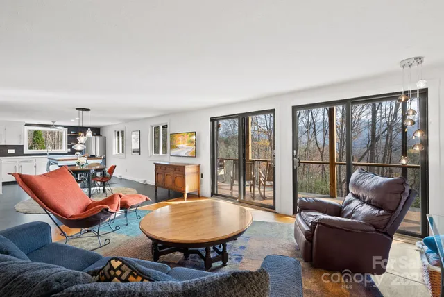a living room with furniture and a floor to ceiling window