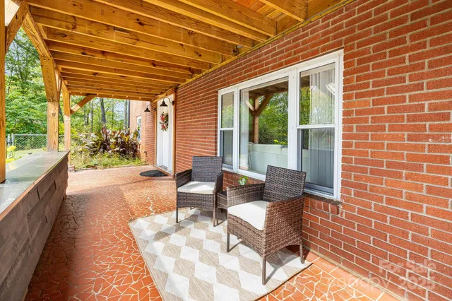 a living room with furniture a rug and a large window