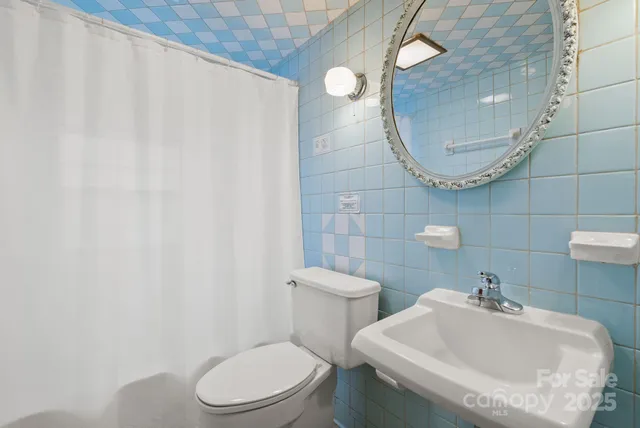 a bedroom with furniture and a large window