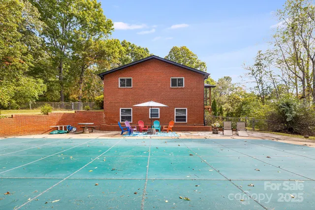 a view of a house with a yard and sitting area