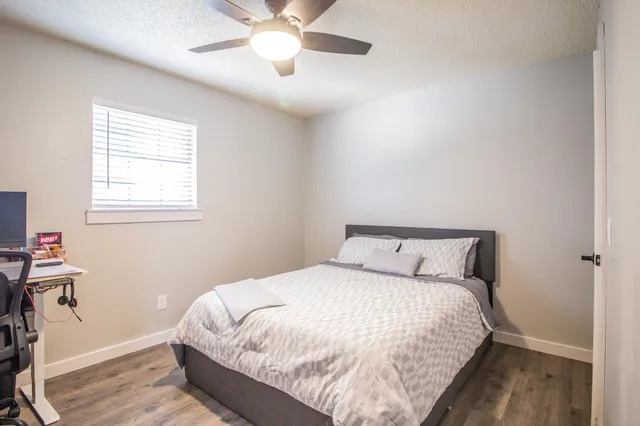a large bed in a bedroom next to a window