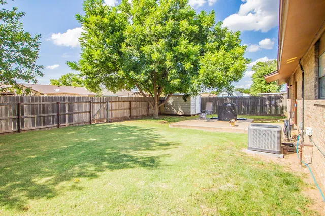 a swimming pool with outdoor seating and yard
