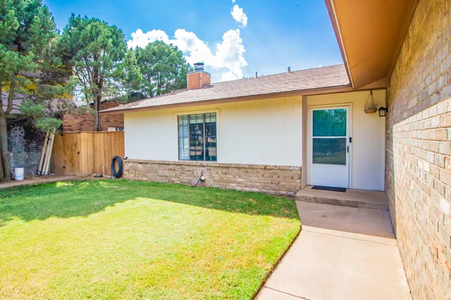 a view of a backyard with potted plants