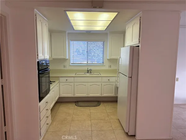 a view of a kitchen from a hallway