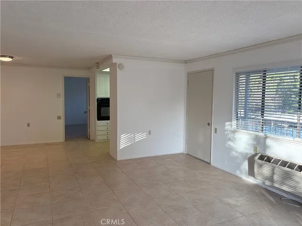 an empty room with windows and pillars in it