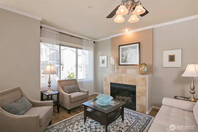 a living room with furniture a chandelier and a fireplace