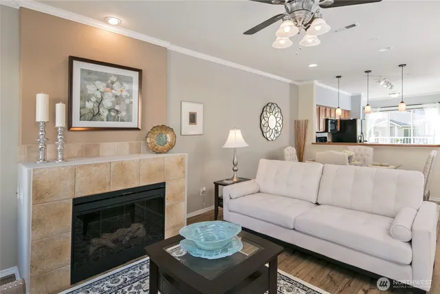 a living room with furniture a clock and a fireplace