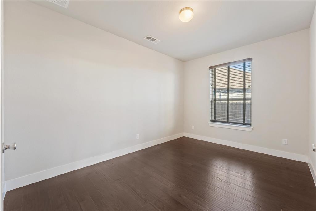 2044 Longbridge Road Forney, TX 75126 - Photo 20 of 40 Room with wood-finish flooring, a window with blinds, and a flush-mount ceiling light fixture