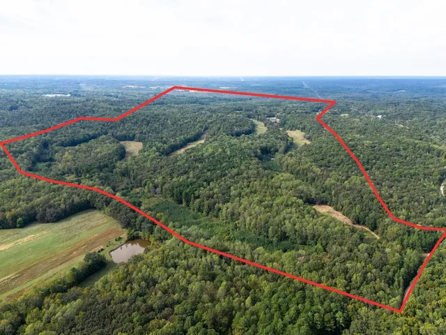 a view of a lake with a table and chairs in the patio