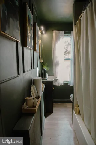 a living room with furniture and a mirror