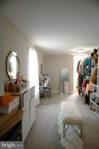 a room with furniture a air conditioner vent and a window