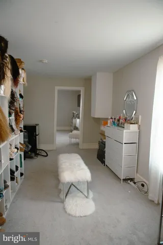 a bedroom with a bed window and a flat screen tv