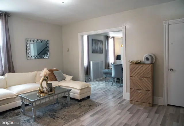 a living room with furniture and wooden floor