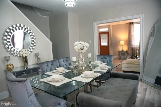 a living room with furniture and a large mirror