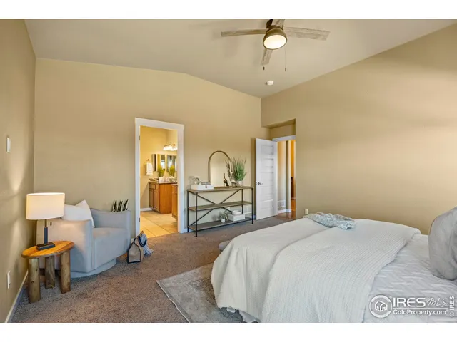 a bedroom with a bed window and couch