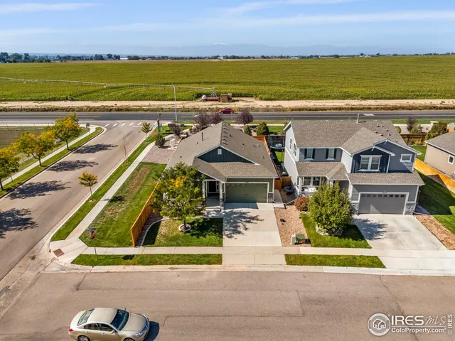 an aerial view of residential houses with outdoor space and ocean view