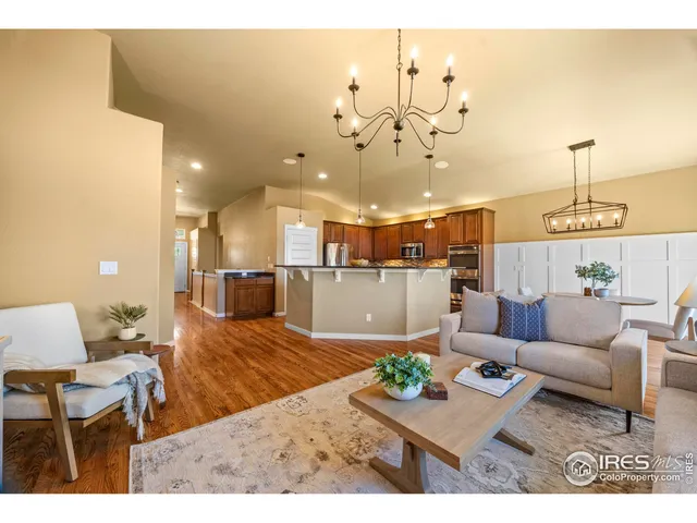 a living room with kitchen island furniture and a chandelier