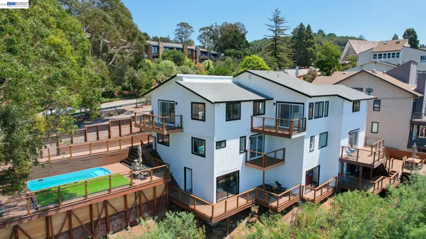 an aerial view of a house with balcony and garden