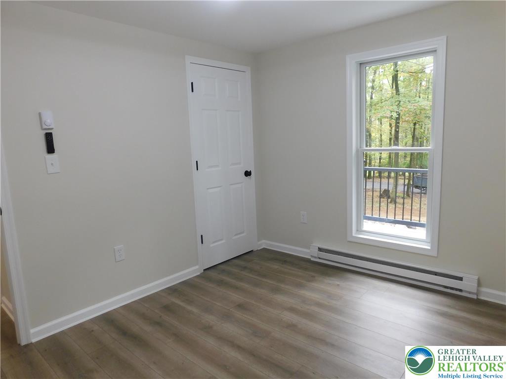1405 Donalds Road Effort, PA 18330 - Photo 30 of 31 a view of an empty room with wooden floor and a window