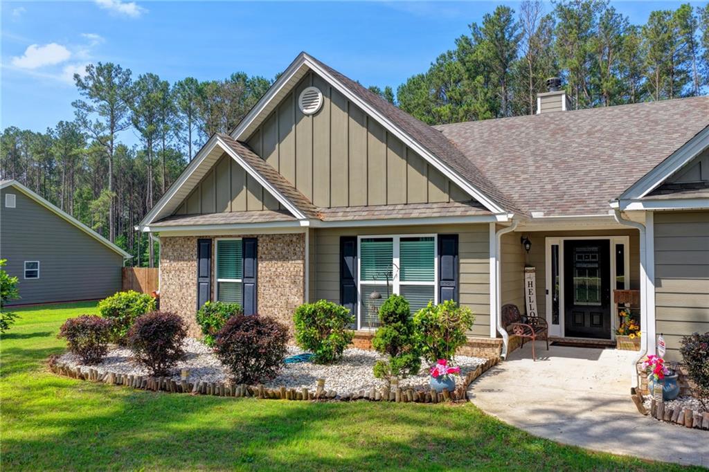 204 Lynn Road Bethlehem, GA 30620 - Photo 42 of 44 a front view of a house with a garden and plants