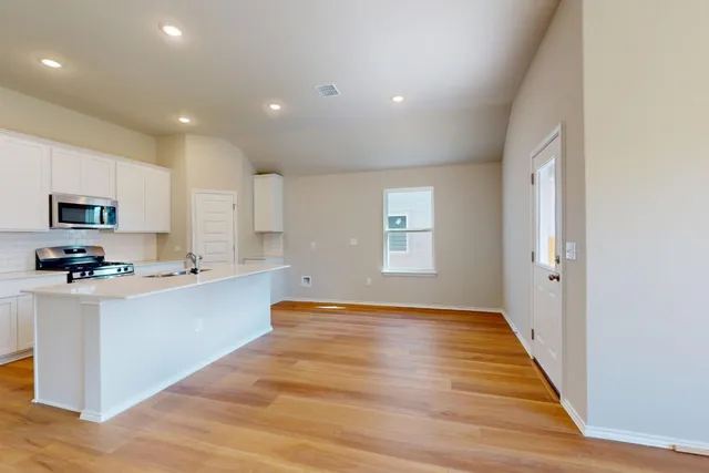 a view of kitchen with sink and microwave