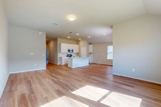 a view of kitchen and hall with wooden floor