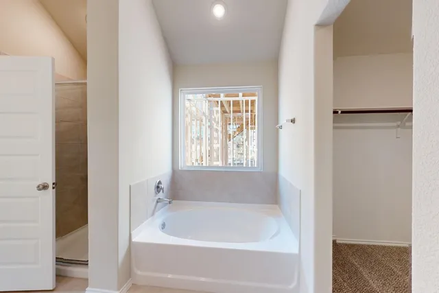 a white bath tub sitting next to a window