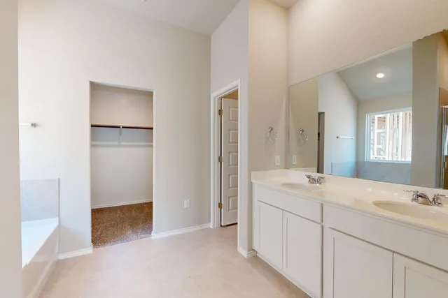 a bathroom with a sink a mirror and a shower