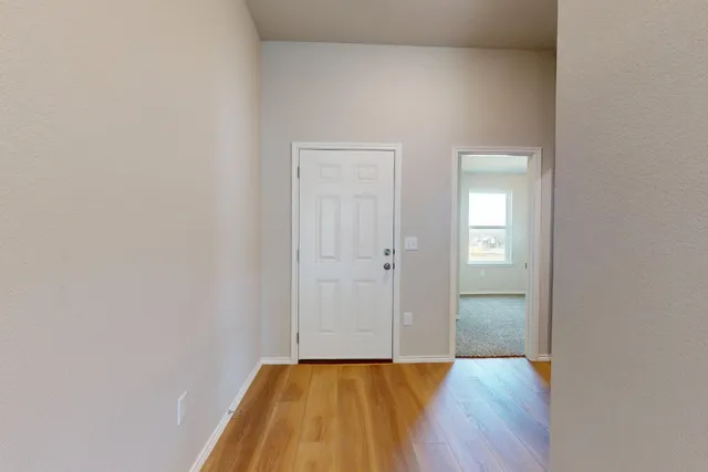 a view of a livingroom with wooden floor and closet
