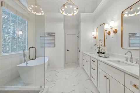 a spacious bathroom with a double vanity sink a mirror a shower and a bathtub