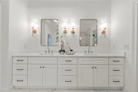 a white bath tub sitting next to a shower