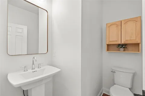 a view of kitchen with white cabinets