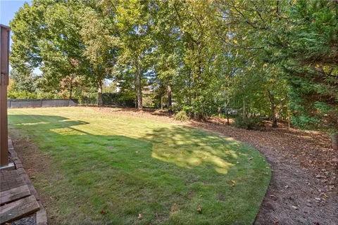 a view of a yard with large trees