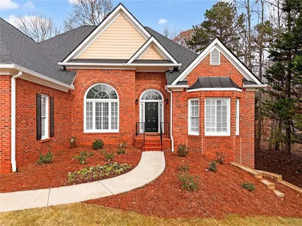 an aerial view of a house with swimming pool and sitting area