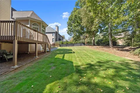 a view of a house with a yard and sitting area