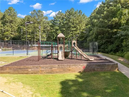 a view of a swimming pool with a chair and tables