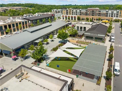 a view of a swimming pool with a patio and a yard