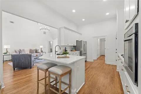 a large kitchen with a table and chairs