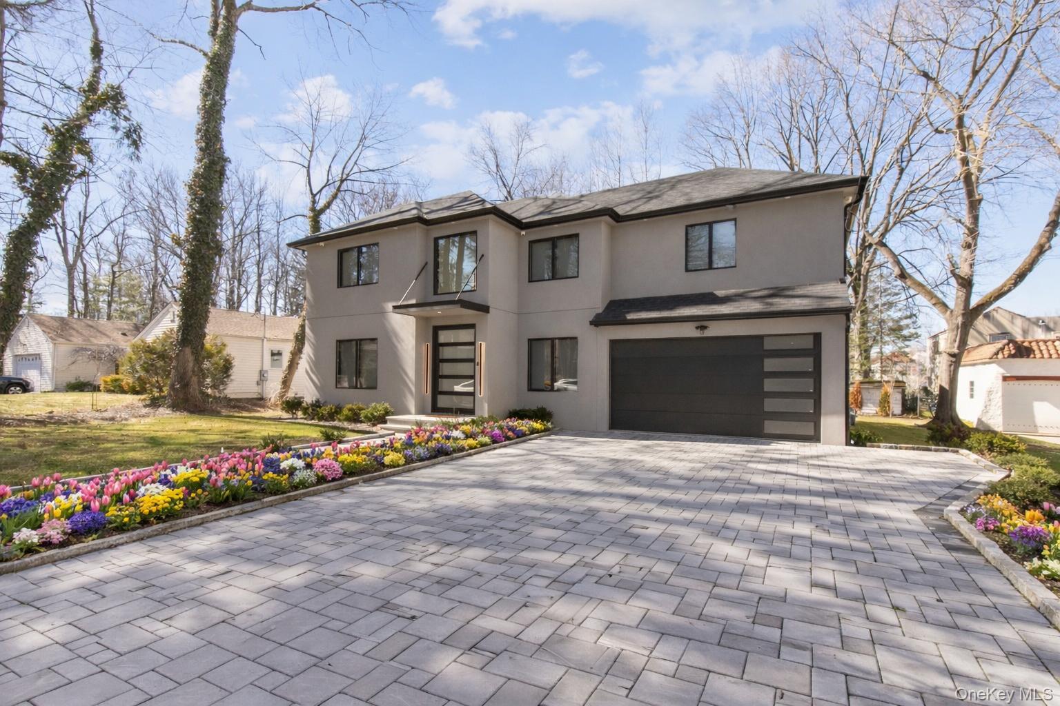 a front view of a house with a yard and a garage