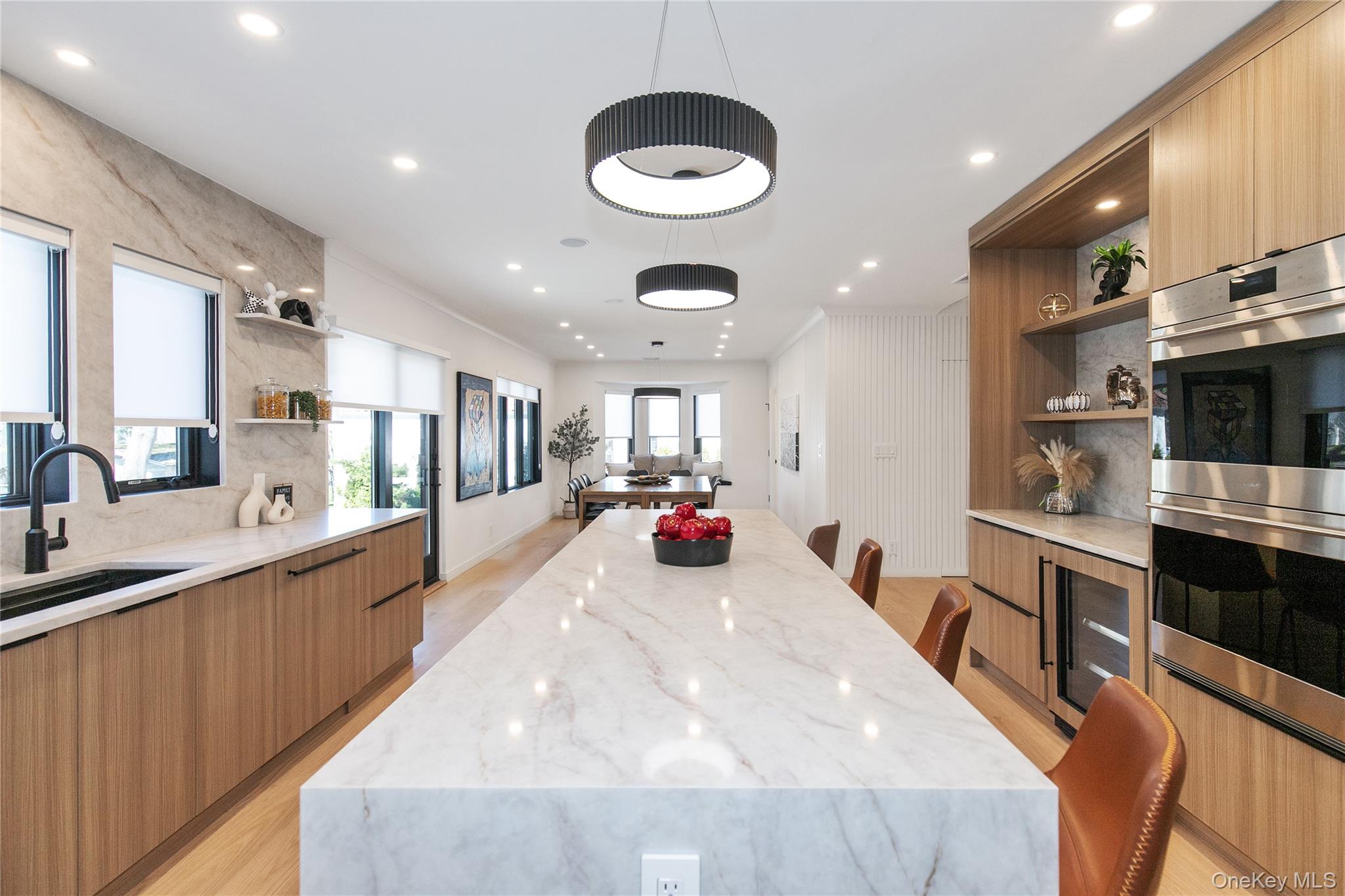 1 Bentley Road Great Neck, NY 11023 - Photo 12 of 34 a large kitchen with stainless steel appliances a large counter top a stove and a sink