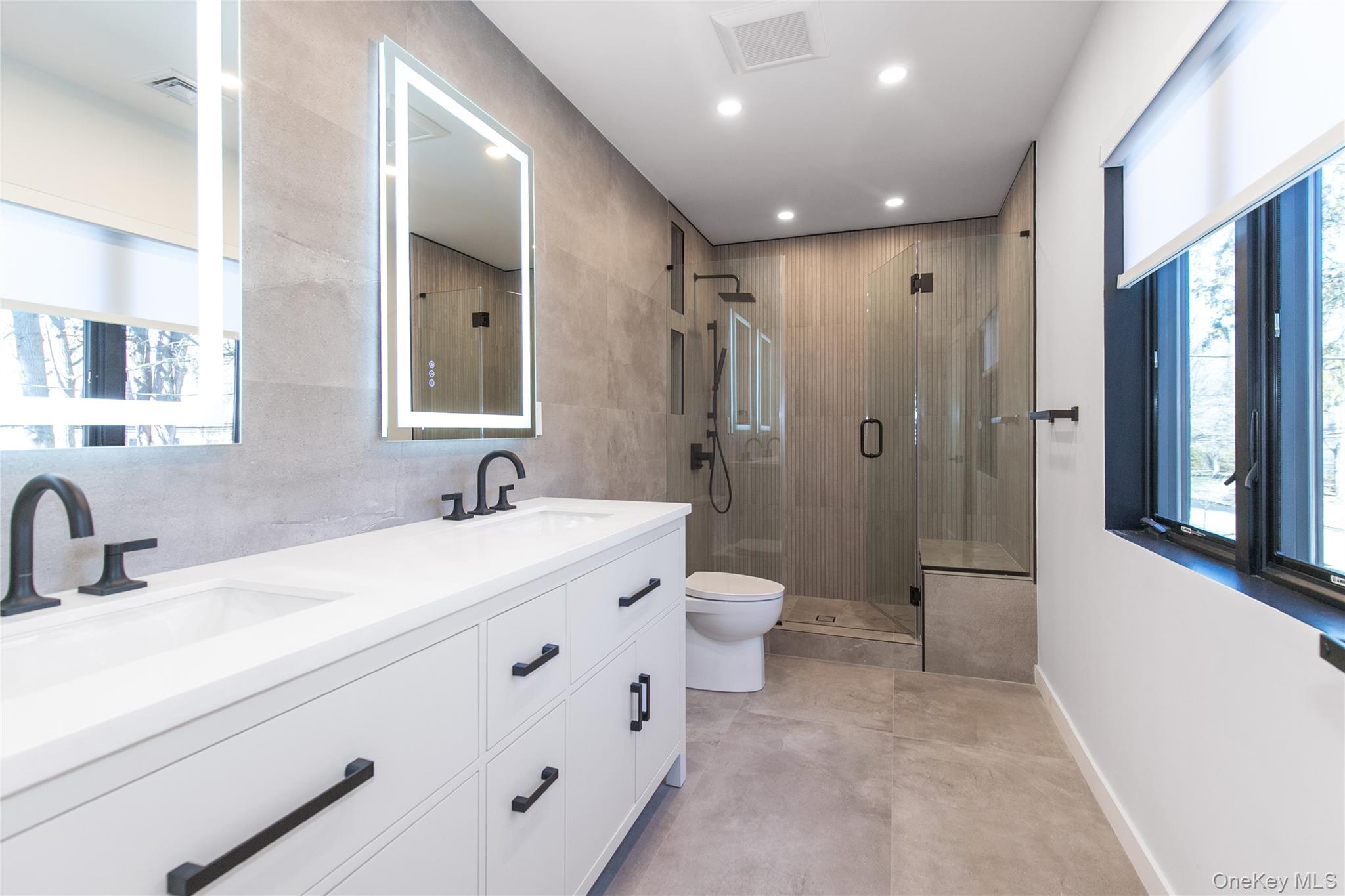 1 Bentley Road Great Neck, NY 11023 - Photo 23 of 34 a spacious bathroom with double sink a toilet a shower and a mirror
